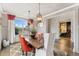 Bright dining room with a wood table, orange chairs and ample natural light with hardwood floors at 21962 E Idyllwilde Dr, Parker, CO 80138