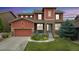 Inviting two-story home with a blend of stone and siding, complemented by a lush front yard at 21962 E Idyllwilde Dr, Parker, CO 80138