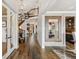 Grand foyer featuring hardwood floors, a curved staircase, and elegant decorative mirror at 21962 E Idyllwilde Dr, Parker, CO 80138