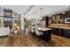 Modern kitchen featuring a large island with seating, stainless steel appliances, and hardwood floors at 21962 E Idyllwilde Dr, Parker, CO 80138