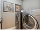Well-equipped laundry room with modern washer and dryer units and neutral walls at 21962 E Idyllwilde Dr, Parker, CO 80138