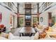 Bright living room showcasing stone fireplace, tall windows, and comfortable seating arrangement at 21962 E Idyllwilde Dr, Parker, CO 80138