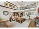 Open living room with an upstairs balcony and views to the kitchen and dining area at 21962 E Idyllwilde Dr, Parker, CO 80138