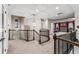 Staircase view of the curved wrought iron railing and neutral carpeted loft space at 21962 E Idyllwilde Dr, Parker, CO 80138
