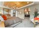 Luxurious main bedroom with a decorative ceiling, carpeted floors, sitting area, and ensuite bathroom at 21962 E Idyllwilde Dr, Parker, CO 80138