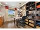 Home office featuring custom built-ins, a large window, and hardwood floors at 21962 E Idyllwilde Dr, Parker, CO 80138