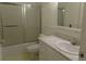 Small bathroom with marble countertops and combination bathtub and shower at 580 S Clinton St # 10D, Denver, CO 80247