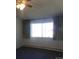 Modest bedroom featuring carpet floors, a ceiling fan, and a window with curtains at 580 S Clinton St # 10D, Denver, CO 80247