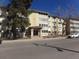 Attractive multi-story condo building with mature trees and street parking at 580 S Clinton St # 10D, Denver, CO 80247