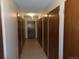 Long hallway with multiple light brown doors on either side leading to apartments and beige tile floor at 580 S Clinton St # 10D, Denver, CO 80247