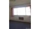 Standard living room with carpet floors, large windows, and simple neutral curtains at 580 S Clinton St # 10D, Denver, CO 80247