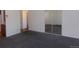 View of a living room area with large sliding mirror closet door, and access to another room at 580 S Clinton St # 10D, Denver, CO 80247