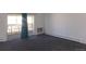 Carpeted living room with large window and access to an enclosed balcony at 580 S Clinton St # 10D, Denver, CO 80247
