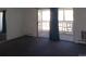 Spacious carpeted living room with access to an enclosed balcony at 580 S Clinton St # 10D, Denver, CO 80247