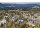 Modern home with solar panels nestled among trees, showcasing mountain views and neighborhood setting at 10354 Georgia Cir, Morrison, CO 80465