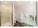 Modern bathroom with glass enclosed shower, floating sink, and tile floors at 10354 Georgia Cir, Morrison, CO 80465