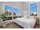 Bright bedroom boasts large windows with lovely outdoor views and cozy, neutral decor at 10354 Georgia Cir, Morrison, CO 80465