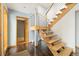 An inviting foyer featuring modern wood stairs with steel railing and dark tile flooring at 10354 Georgia Cir, Morrison, CO 80465