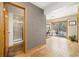 Hallway featuring wood floors, a view of the backyard through sliding glass door and a bathroom at 10354 Georgia Cir, Morrison, CO 80465