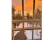 A stunning sunset illuminates trees seen through multi-pane windows at 10354 Georgia Cir, Morrison, CO 80465