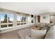 Bright living room features carpeting, comfortable seating and oversized windows with outdoor views at 10354 Georgia Cir, Morrison, CO 80465