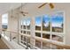 Modern loft space with metal railing features large windows with breathtaking mountain views at 10354 Georgia Cir, Morrison, CO 80465