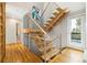 Modern staircase featuring wooden stairs and stainless steel railings at 10354 Georgia Cir, Morrison, CO 80465