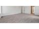 Large bedroom with neutral carpeting and a doorway leading to an adjacent room at 9253 Truckee Ct, Commerce City, CO 80022