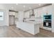 Bright kitchen with an island, stainless appliances, and ample counter space at 9253 Truckee Ct, Commerce City, CO 80022
