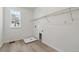 Well-lit laundry room with wood-look flooring and a utility sink at 9253 Truckee Ct, Commerce City, CO 80022
