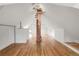 Wide attic featuring exposed wood beams, a brick support and finished floors at 3905 Tejon St, Denver, CO 80211
