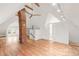 Spacious attic featuring a brick chimney, wood beams and bright lighting at 3905 Tejon St, Denver, CO 80211