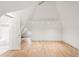 Finished attic space with hardwood floors, a tiled bathroom, and modern lighting at 3905 Tejon St, Denver, CO 80211