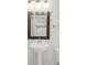 Bathroom sink and vanity with mirror reflecting tiled shower with a small mosaic accent at 3905 Tejon St, Denver, CO 80211