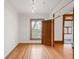 Empty bedroom showcasing natural light, hardwood floors, and a view of the outdoor landscape at 3905 Tejon St, Denver, CO 80211