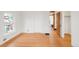 A room with hardwood floors and trim, featuring a walk-in closet and a glimpse of the bathroom at 3905 Tejon St, Denver, CO 80211