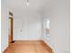 A bright bedroom with white walls, hardwood flooring and a classic door at 3905 Tejon St, Denver, CO 80211