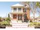 Charming two-story brick home featuring a classic front porch and well-maintained landscaping at 3905 Tejon St, Denver, CO 80211
