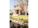 Lovely brick home with a welcoming front porch and meticulously landscaped front yard with vibrant flowers at 3905 Tejon St, Denver, CO 80211