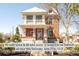 Charming two-story red brick home with a covered front porch and well-maintained landscaping at 3905 Tejon St, Denver, CO 80211