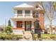 Charming two-story brick home with a covered front porch and colorful landscaping, offering classic curb appeal at 3905 Tejon St, Denver, CO 80211