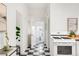 Hallway with tile flooring, white walls and doors leading to multiple rooms in the house at 3905 Tejon St, Denver, CO 80211