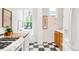 Bright kitchen features stainless steel appliances, white cabinetry, wood countertop, and a large window at 3905 Tejon St, Denver, CO 80211