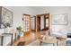 Open-concept living space with hardwood floors, wood trim, glass doors and stylish furnishings at 3905 Tejon St, Denver, CO 80211