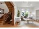 Elegant living room featuring hardwood floors, a stained glass window, and an open staircase at 3905 Tejon St, Denver, CO 80211