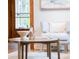Bright living space showcasing a round table and neutral-toned chair next to a decorative window at 3905 Tejon St, Denver, CO 80211