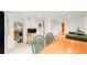 Open-concept living space with hardwood floors, dining area, kitchen, and bright natural light at 3905 Tejon St, Denver, CO 80211