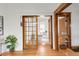 Open office space features glass doors, wooden trim and a modern desk near a window at 3905 Tejon St, Denver, CO 80211