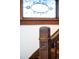 Close-up of wooden staircase with decorative carved details on the post and stained glass window at 3905 Tejon St, Denver, CO 80211
