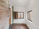 Bright sunroom with exposed brick, original columns, and large windows offering ample natural light and views at 3905 Tejon St, Denver, CO 80211